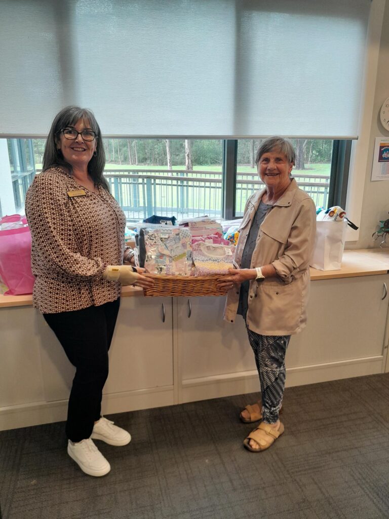 2 Women displaying donated pyjamas